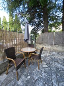 a patio with a table and chairs and an umbrella at Apartmani Dado in Sutomore