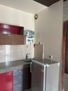 a kitchen with a sink and a refrigerator at The Comfort stays gomti nagar in Lucknow