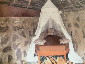 a bed with a canopy in a room at Casa Jujube - Guest House in Dakar