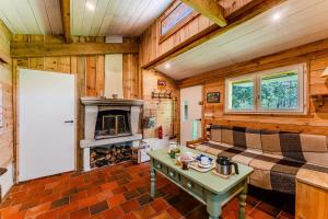 a living room with a bed and a fireplace at La palombière in Saint-Symphorien