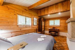 a bedroom with a bed in a wooden room at La palombière in Saint-Symphorien
