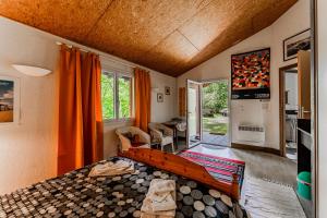a bedroom with a bed and a living room at Le Cabanon Mios in Mios