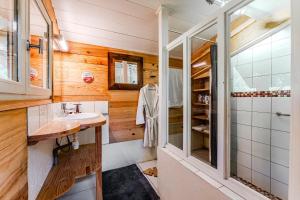a bathroom with a sink and a shower at La palombière in Saint-Symphorien