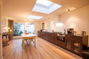 a large kitchen with a table and a skylight at Puur Geluk in Groningen