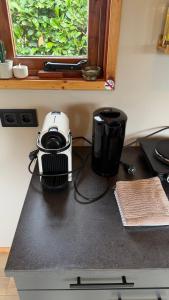 a toaster sitting on top of a counter next to a window at Tinyhouse Giethoorn in Giethoorn