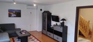 a living room with a couch and a entertainment center at Lake House Ceric in Jajce