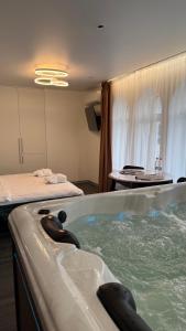 a bathroom with a bath tub with water in it at APETIKO APARTMENTs in Kyiv +82 photos