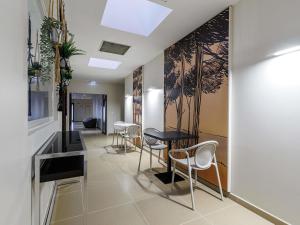a hallway with a table and chairs in a building at Adagio Nice Centre in Nice