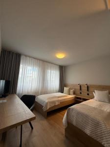 a hotel room with two beds and a television at Central Hotel Winnenden in Winnenden +25 photos