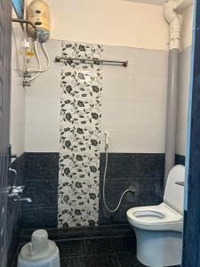 a bathroom with a toilet and a shower at Srilakshmi Residency in Tirupati