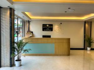 a lobby with a reception desk in a building at Hotel Orelio - Airport Hotel in Bangalore
