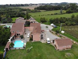 an aerial view of a house with a pool at Communay Gablys Chambres in Communay