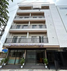 a building with a balcony in front of a building at Hotel Orelio - Airport Hotel in Bangalore