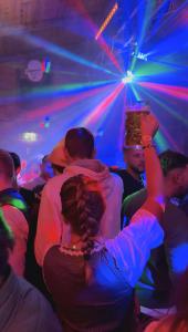 a group of people in a party with lights at Wies'n Camp in Munich