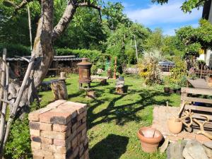 a garden with a brick wall and a tree at Apartma Tanja bike-friendly in Limbuš