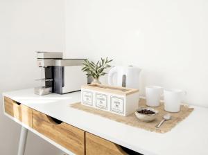 a kitchen counter with a coffee maker and a coffee machine at Casa Del Barone Suites in Monopoli