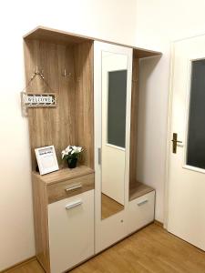 a closet with a mirror and a dresser in a room at Apartman LUXE STAY Vujović in Bileća