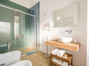 a bathroom with a sink and a glass shower at Casa Del Barone Suites in Monopoli +35 photos