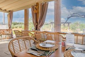 a dining room with a wooden table and chairs at TENUTA DOROLIVO in Otranto
