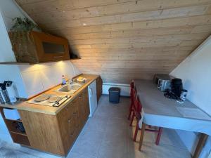 a small kitchen with a sink and a table at Cozy Apartment in Wülfrath +7 photos