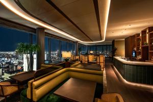 a hotel lobby with a view of the city at The Gate Hotel Osaka by Hulic in Osaka