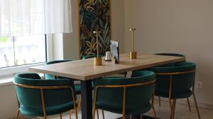 a conference room with a wooden table and blue chairs at Menta Rooms & Bar in Kapuvár