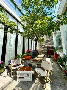 a patio with two chairs and a table and a tree at Peking Station Hostel in Beijing
