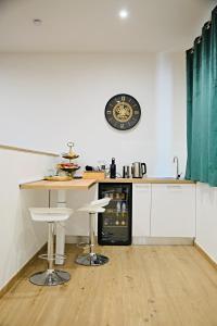 a kitchen with a counter and a clock on the wall at RG MAISON - Suite 29 in Morino