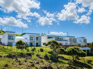 a white building with trees in front of it at Le Marin, Rodrigues Island in Rodrigues Island