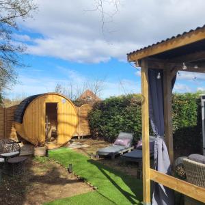 a small garden with a wooden hobbit house at Ecolodge Insolite in La Bâtie-Montgascon