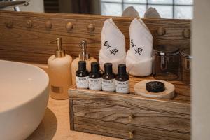 a wooden shelf with bottles of essential oils and towels at Dali Jiwu Hotel in Dali +133 photos