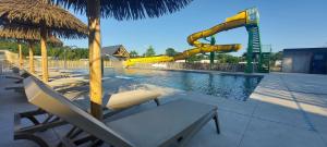 a pool with a water park with a water slide at Zomerhuisje Chalet in Voorthuizen