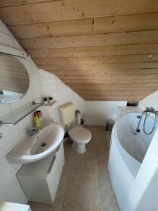 a bathroom with a sink and a tub and a toilet at Cozy Apartment in Wülfrath