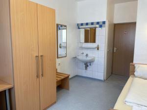 a bathroom with a sink and a toilet and a mirror at Gasthof Kirchberger in Fürth +40 photos