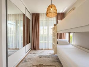 a bedroom with two beds and a large window at Nothern Cyprus Four Seasons Life Collection Apartments & Lofts Seafront in Ayios Dhometios +59 photos