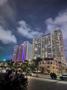 a group of tall buildings in a city with motorcycles at The Sapphire Hòn Gai Apartment - Trung tâm Hạ Long in Ha Long