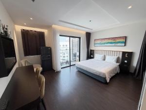 a bedroom with a bed and a television in it at The Sapphire Hòn Gai Apartment - Trung tâm Hạ Long in Ha Long +59 photos