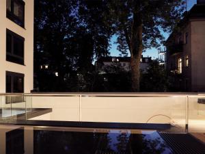 a building with a reflecting pool in front of a building at Schwabinger Wahrheit by Geisel in Munich