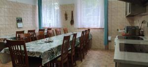 a dining room with a long table and chairs at Dolina Wilema in Bolesławów