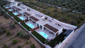 an aerial view of a house with two swimming pools at Kudos Luxury villas in Korinthos