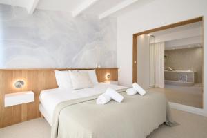 a bedroom with two beds and a large mirror at Villa Halo Lagoon Pool & Exclusive seaside getaway in Cap d'Agde