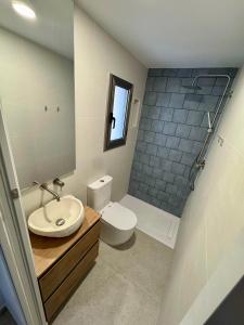 a bathroom with a sink and a toilet at Petit Paradís in Sant Antoni de Calonge +3 photos