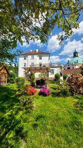 a white house with a gazebo in a yard at Apartmány U Mariánské kaple in Česká Kamenice