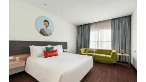 a hotel room with a large white bed and a window at Greenpark Hyderabad in Hyderabad