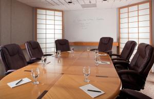 a conference room with a large wooden table and chairs at The Inn at Honey Run Millersburg in Millersburg