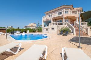 a villa with a swimming pool and a house at Can Martinez in Llucmajor