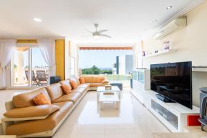 a living room with a large couch and a tv at Can Martinez in Llucmajor