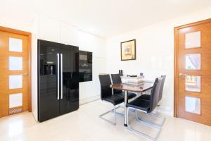 a dining room with a table and black chairs at Can Martinez in Llucmajor
