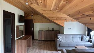 a living room with a couch and wooden ceilings at Alya Teras Otel in Trabzon
