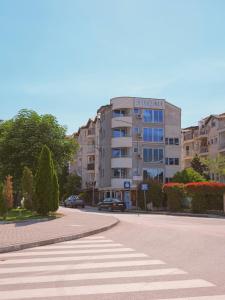 a building on a city street with a crosswalk at Villa Apollo Ohrid Lakeside in Ohrid